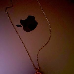 A necklace with Virgin Mary. Has pink glass stones